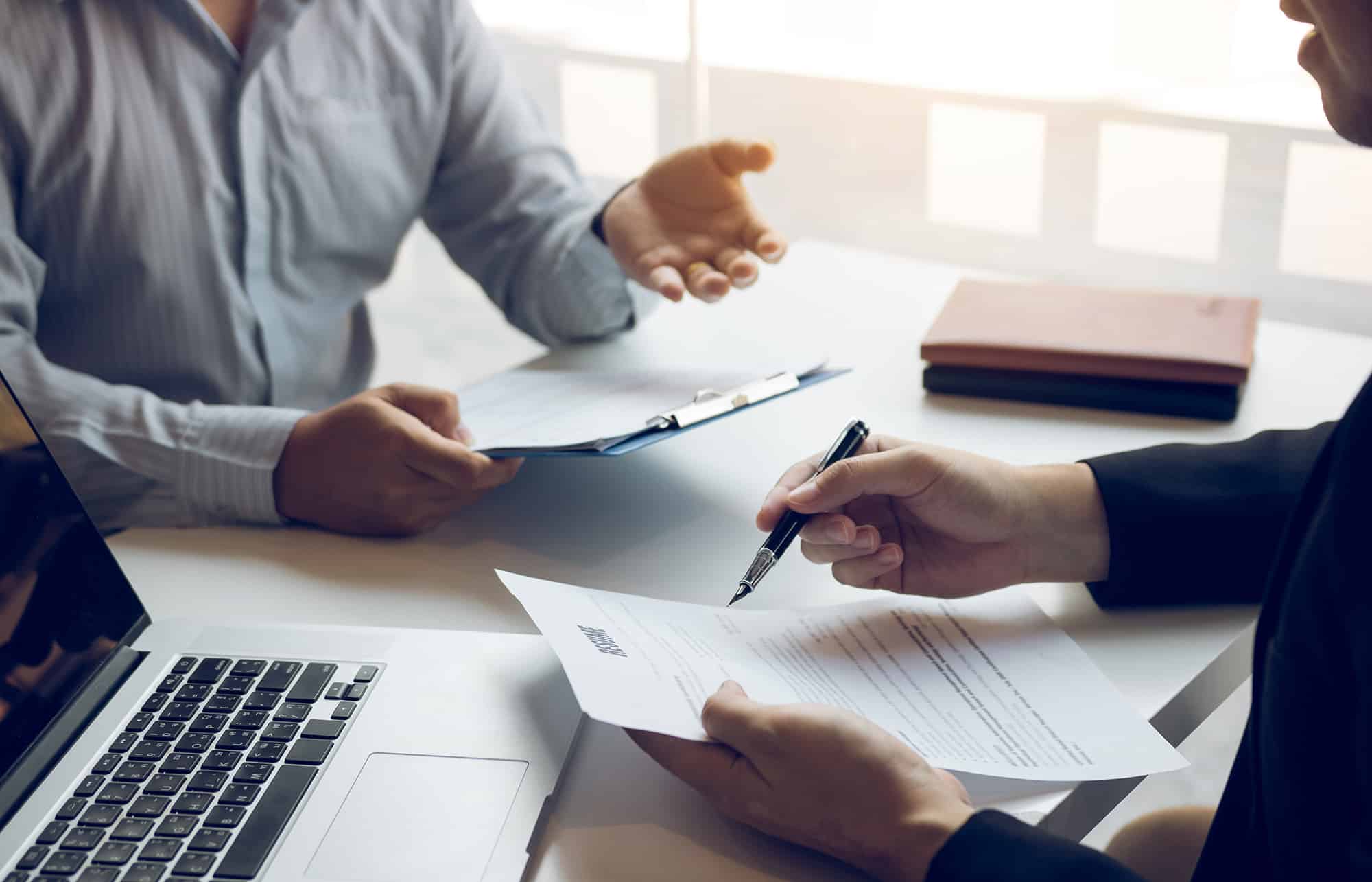 deux hommes en train de discuter face à face dans un bureau